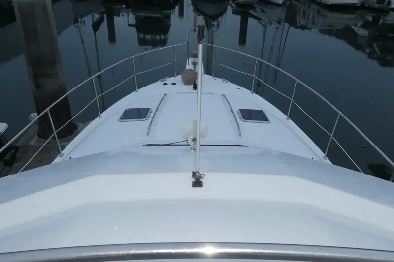 Slide: The Image of 1994 Bayliner 4388 Motor Yacht docked, view from bow, calm marina setting. - 44