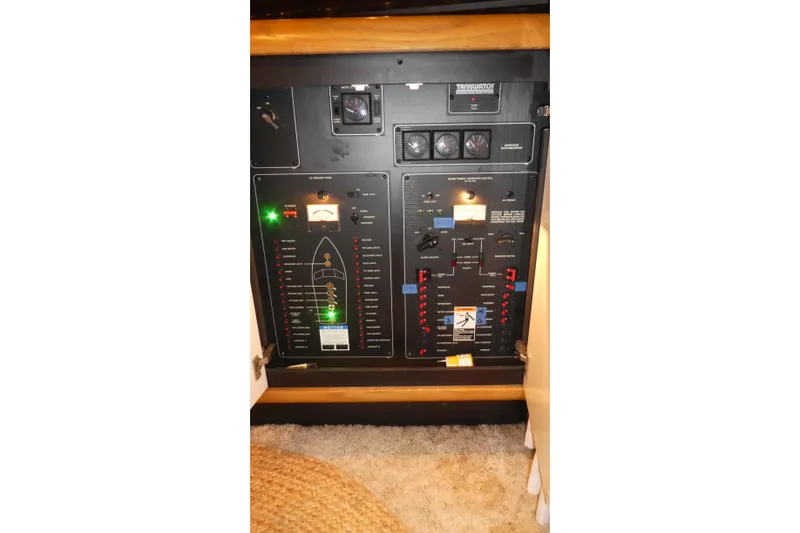 Slide: The Image of Electrical control panel of 1994 Bayliner 4388 Motor Yacht, featuring various switches and indicators. - 46