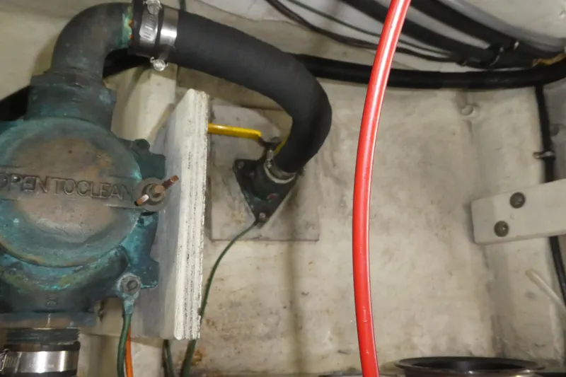 Slide: The Image of Engine compartment of 1994 Bayliner 4388 Motor Yacht with visible hoses and components. - 54