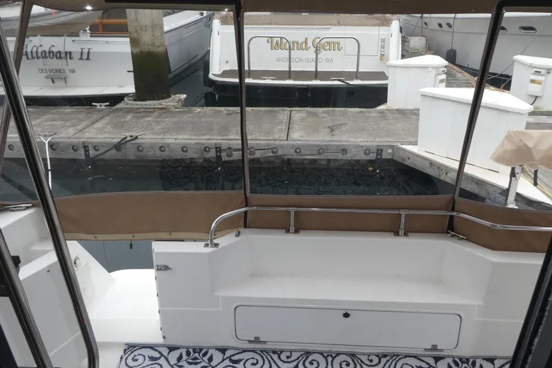 Slide: The Image of 1994 Bayliner 4388 Motor Yacht docked at marina, view from rear seating area. - 7