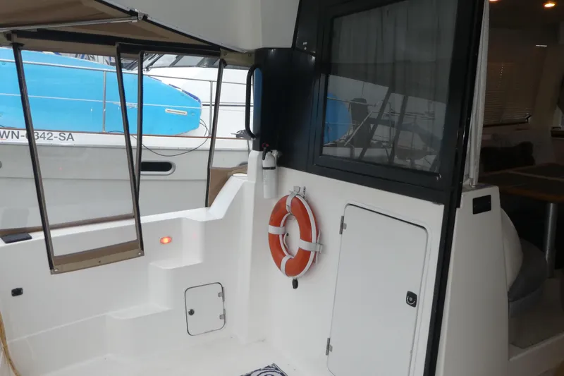 Slide: The Image of 1994 Bayliner 4388 Motor Yacht deck with life preserver and cabin entrance. - 8