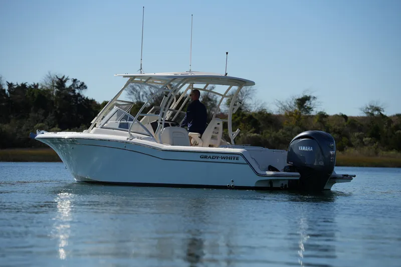 Slide: The Image of 2022 Grady-White Freedom 235 boat on calm water with Yamaha engine. - 10