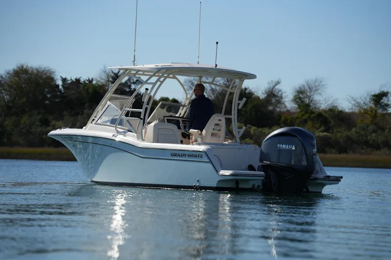 Slide: The Image of 2022 Grady-White Freedom 235 boat on calm water with Yamaha engine. - 11