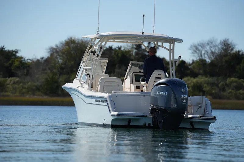 Slide: The Image of 2022 Grady-White Freedom 235 boat with Yamaha engine on calm water. - 12