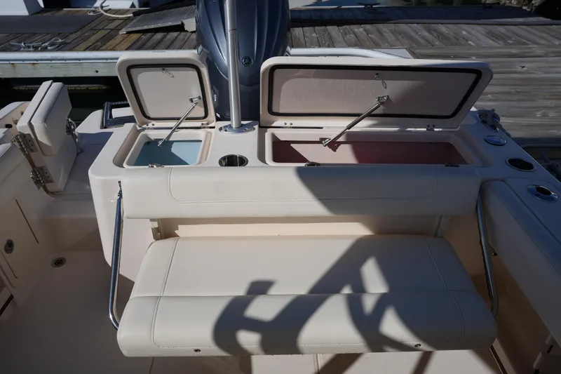 Slide: The Image of 2022 Grady-White Freedom 235 boat interior with open storage compartments. - 15
