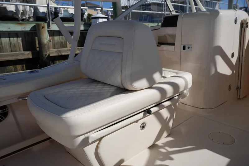 Slide: The Image of Luxurious seating on 2022 Grady-White Freedom 235 boat, featuring elegant white upholstery. - 16