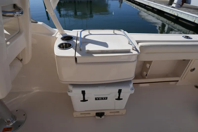 Slide: The Image of 2022 Grady-White Freedom 235 boat interior with Yeti cooler and cup holders. - 18