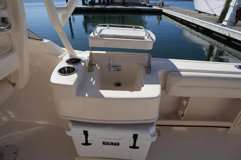 Slide: The Image of 2022 Grady-White Freedom 235 boat interior with sink and Yeti cooler. - 19