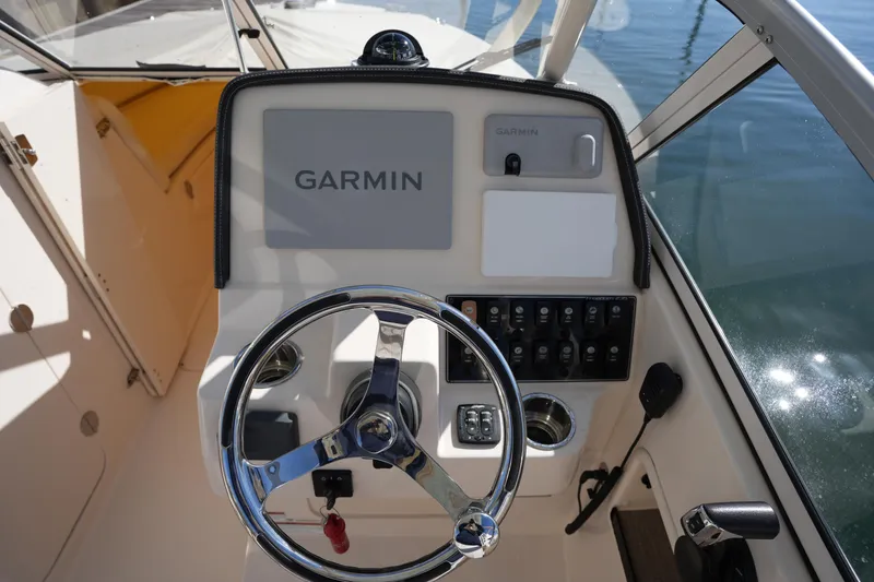 Slide: The Image of 2022 Grady-White Freedom 235 boat dashboard with Garmin navigation system. - 22