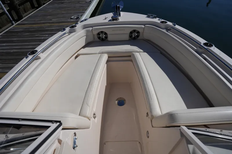 Slide: The Image of 2022 Grady-White Freedom 235 boat interior with cushioned seating and sleek design. - 28
