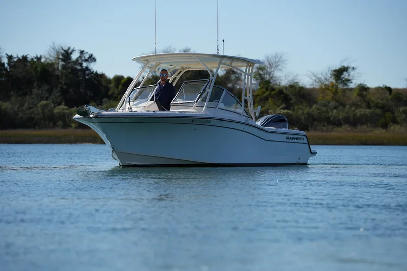 Slide: The Image of 2022 Grady-White Freedom 235 boat cruising on calm water. - 6