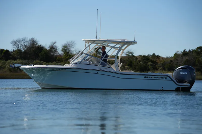 Slide: The Image of 2022 Grady-White Freedom 235 boat on calm water with Yamaha engine. - 7