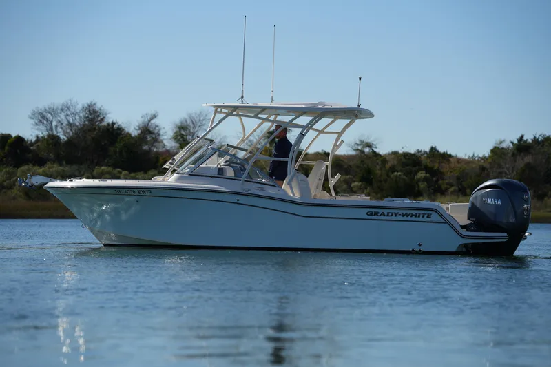 Slide: The Image of 2022 Grady-White Freedom 235 boat on calm water, side view. - 8