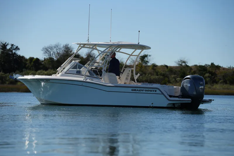 Slide: The Image of 2022 Grady-White Freedom 235 boat on calm water, side view. - 9