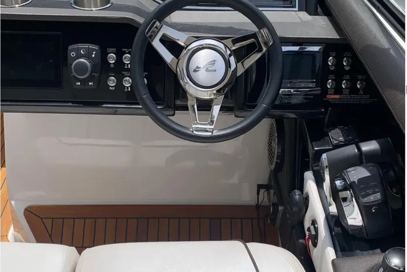 Slide: The Image of Steering console of 2018 Sea Ray SLX 310 boat with modern controls and dashboard. - 11