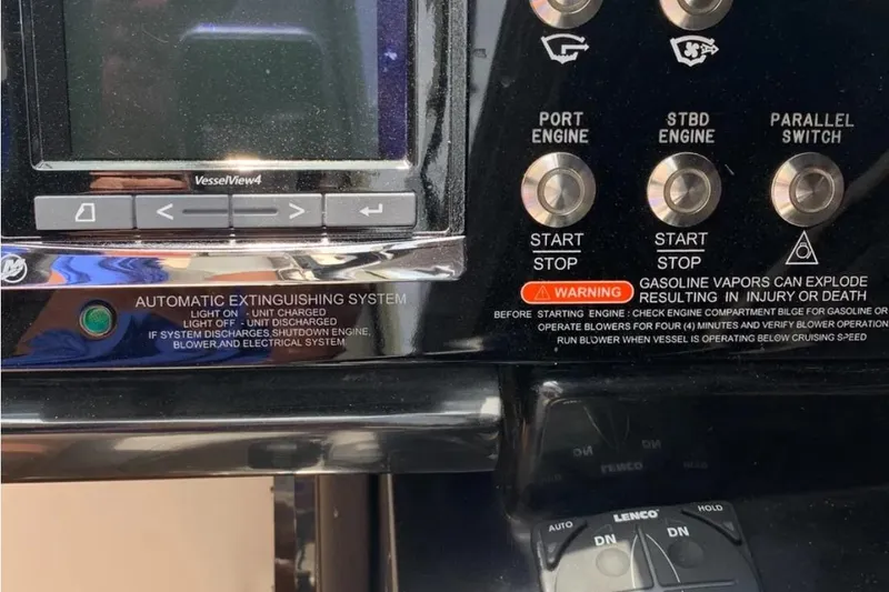 Slide: The Image of Control panel of a 2018 Sea Ray SLX 310 boat with safety warnings and engine controls. - 12