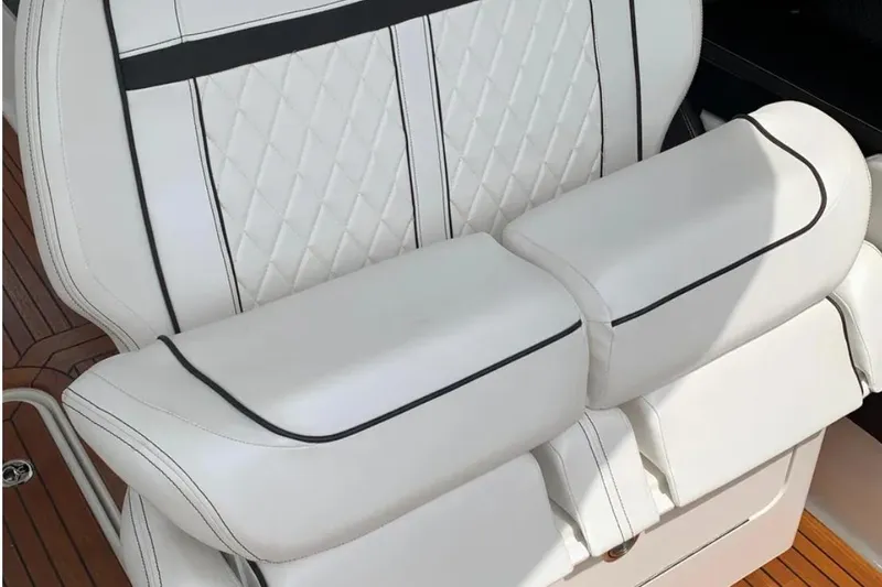 Slide: The Image of Luxurious white leather seating on 2018 Sea Ray SLX 310 boat, featuring elegant stitching. - 19