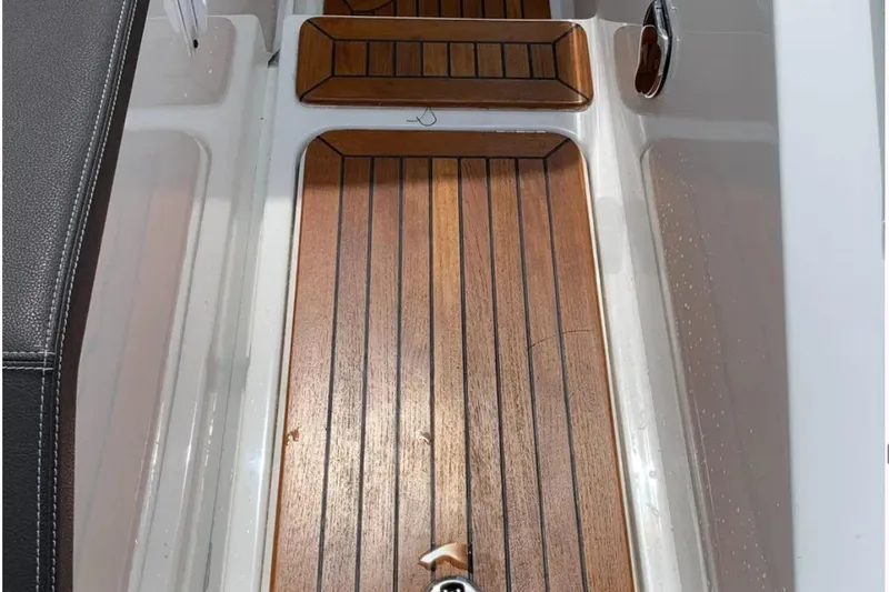 Slide: The Image of Teak flooring on 2018 Sea Ray SLX 310 boat interior. - 24