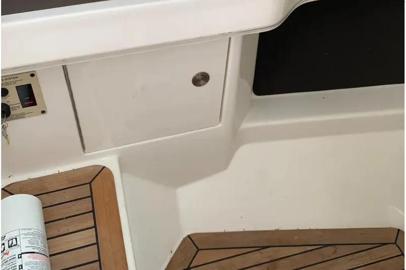 Slide: The Image of 2018 Sea Ray SLX 310 boat deck with wood finish and control panel. - 30