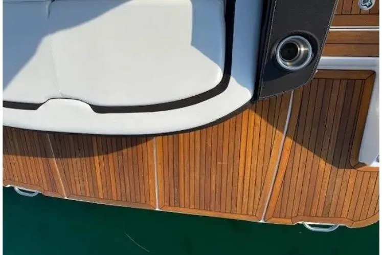 Slide: The Image of 2018 Sea Ray SLX 310 boat with teak deck and white seating. - 32
