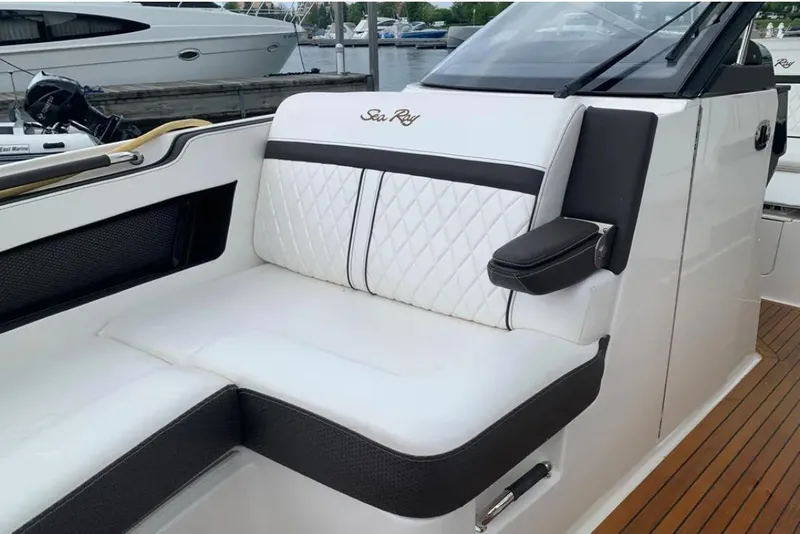 Slide: The Image of 2018 Sea Ray SLX 310 boat interior with white leather seating and elegant design. - 6