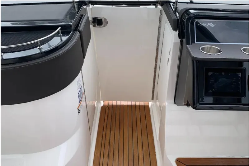 Slide: The Image of 2018 Sea Ray SLX 310 boat interior with teak flooring and sleek design. - 8