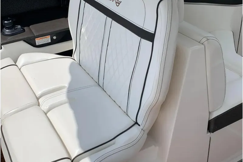 Slide: The Image of 2018 Sea Ray SLX 310 boat seat with white upholstery and black accents. - 9