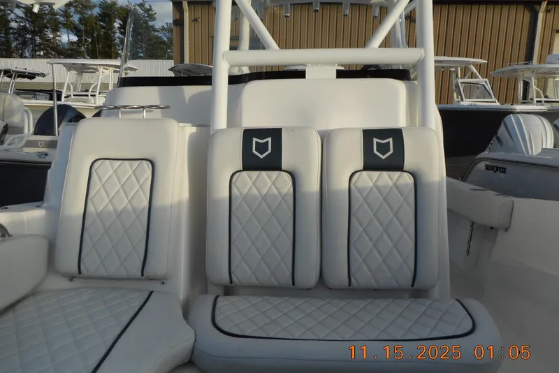 Slide: The Image of 2026 Sea Fox 248 Side Console boat interior with white quilted seating. - 17