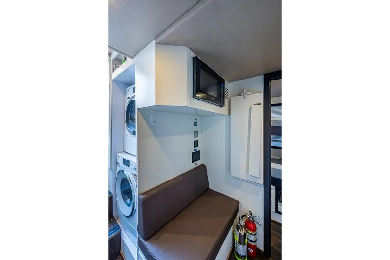 Slide: The Image of Laundry area in 2017 Azimut 80 yacht with washer, dryer, and seating. - 113