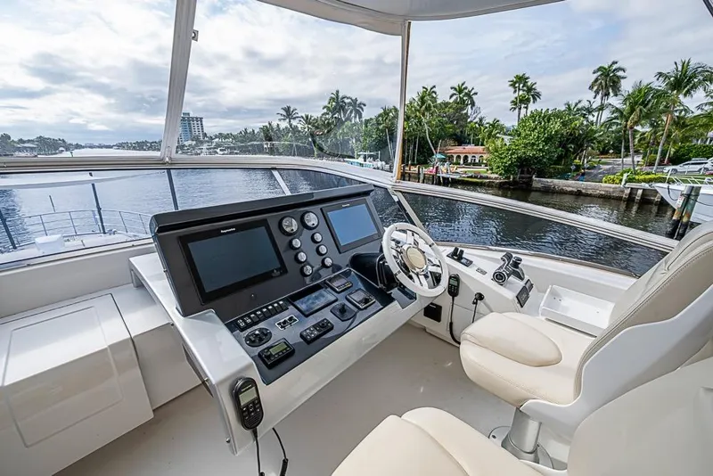 Slide: The Image of Helm of 2017 Azimut 80 yacht with modern controls and scenic waterfront view. - 30