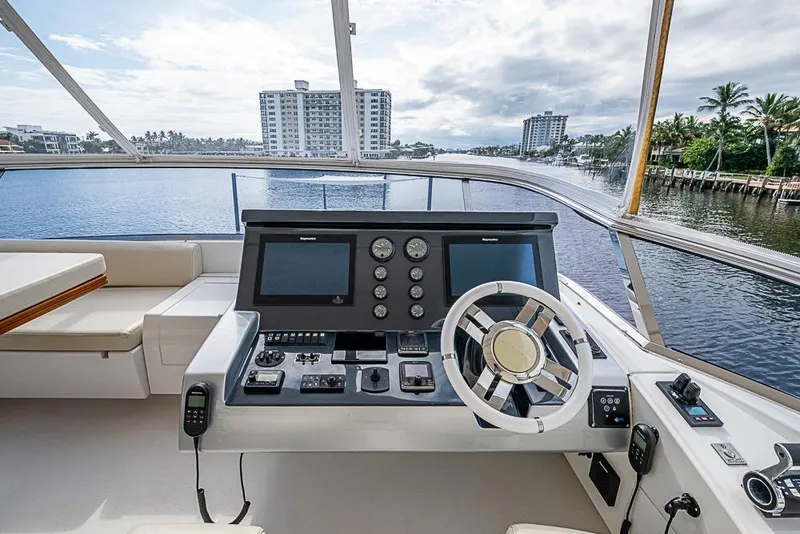 Slide: The Image of Cockpit view of 2017 Azimut 80 yacht with modern navigation controls and waterfront scenery. - 31