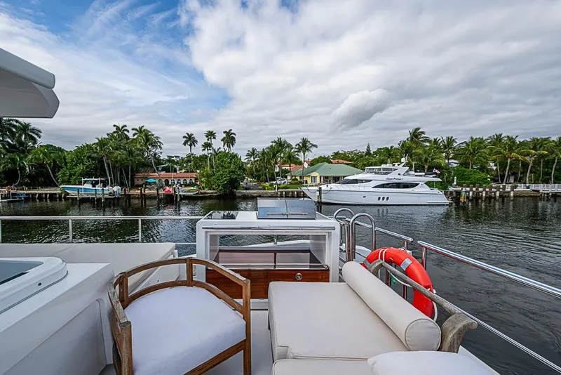 Slide: The Image of Luxurious 2017 Azimut 80 yacht deck with scenic waterfront view and palm trees. - 36