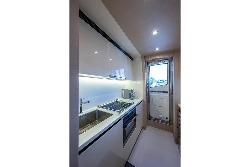 Slide: The Image of Modern kitchen interior on 2017 Azimut 80 yacht, featuring sleek cabinetry and stainless steel appliances. - 64