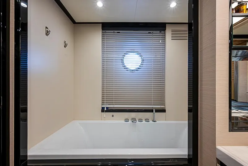 Slide: The Image of Luxurious bathroom on 2017 Azimut 80 yacht with modern bathtub and porthole window. - 94