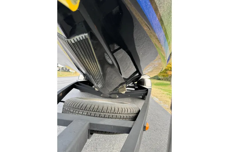 Slide: The Image of 2017 Triton 20 TrX Patriot boat on trailer, close-up of hull and tire. - 10