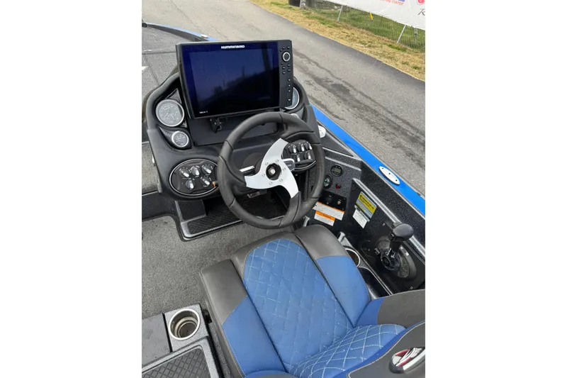Slide: The Image of 2017 Triton 20 TrX Patriot boat cockpit with steering wheel and navigation display. - 6