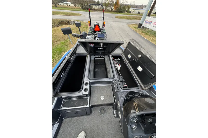 Slide: The Image of 2017 Triton 20 TrX Patriot boat interior with open storage compartments. - 8