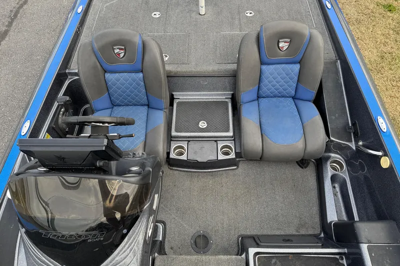 Slide: The Image of 2017 Triton 20 TrX Patriot boat interior with dual blue and gray seats. - 9