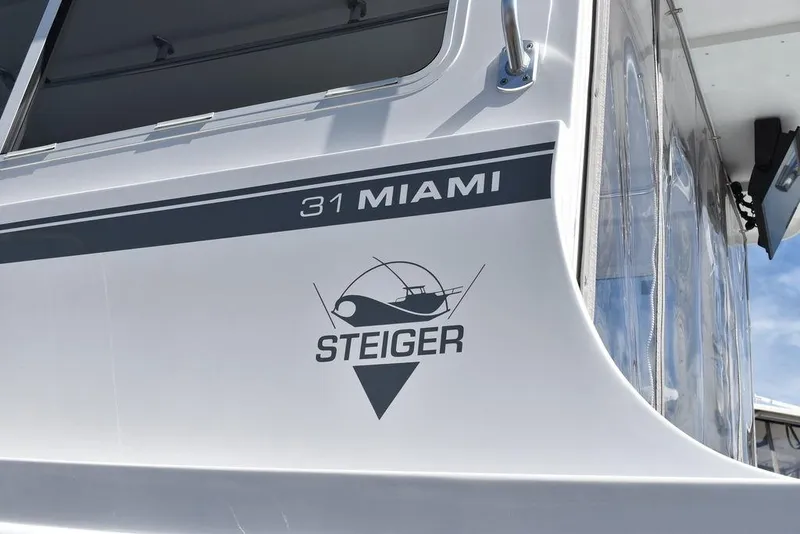 Slide: The Image of 2023 Steiger Craft 31 Miami boat exterior with logo and model name. - 11