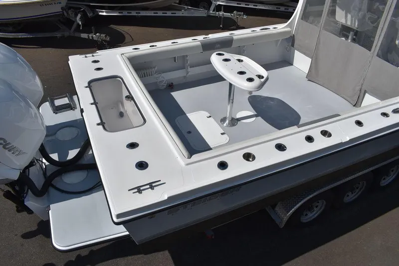 Slide: The Image of 2023 Steiger Craft 31 Miami boat deck with fishing rod holders and seating. - 13