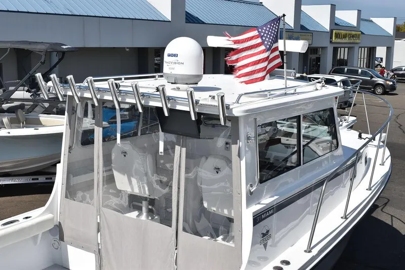 Slide: The Image of 2023 Steiger Craft 31 Miami boat with American flag, docked at marina. - 15