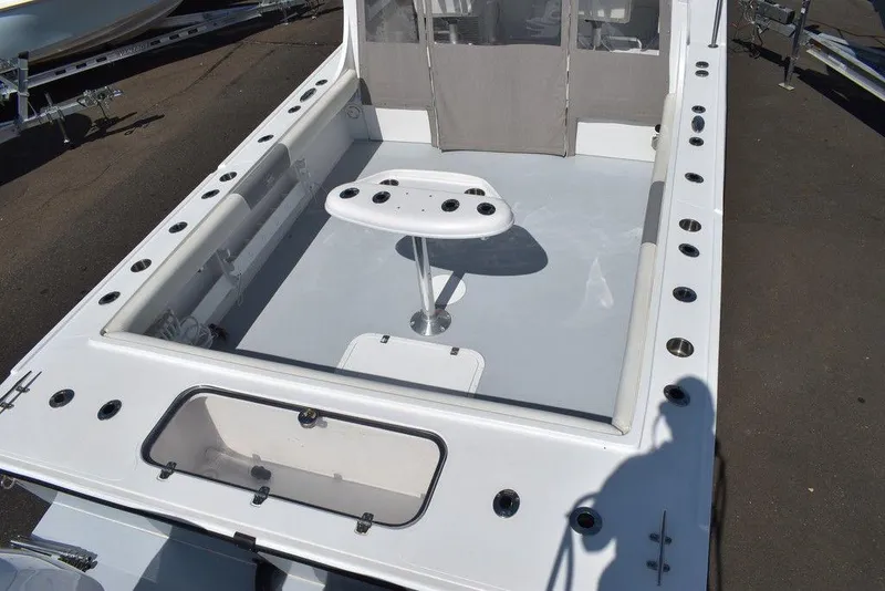 Slide: The Image of 2023 Steiger Craft 31 Miami boat deck with rod holders and seating area. - 17