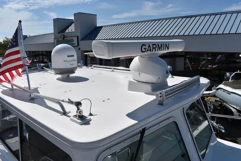 Slide: The Image of 2023 Steiger Craft 31 Miami boat with Garmin radar and American flag. - 21