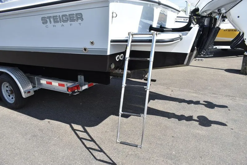 Slide: The Image of 2023 Steiger Craft 31 Miami boat on trailer with ladder. - 33