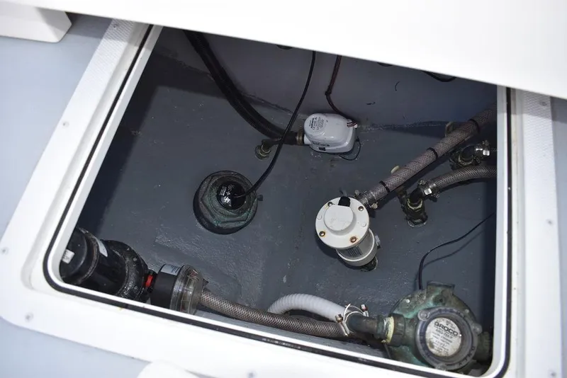 Slide: The Image of 2023 Steiger Craft 31 Miami boat bilge area with pumps and hoses. - 44