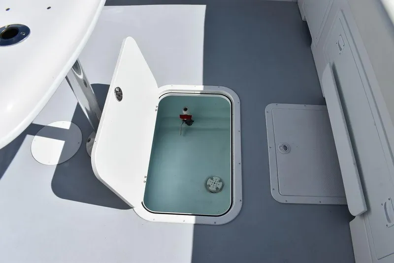 Slide: The Image of 2023 Steiger Craft 31 Miami boat deck with open hatch and storage compartment. - 45