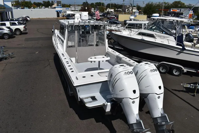 Slide: The Image of 2023 Steiger Craft 31 Miami boat with twin 400 horsepower engines in a marina. - 8