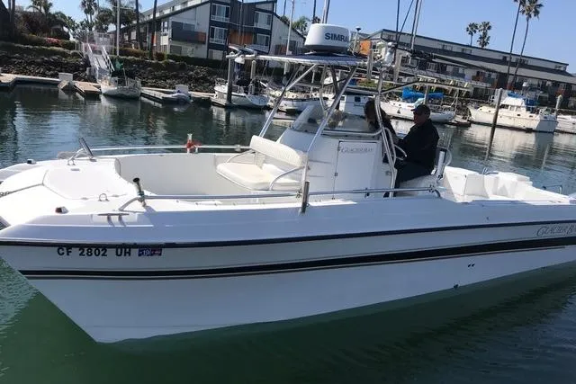 Slide: The Image of 2005 Glacier Bay 260 Canyon Runner boat docked in marina, calm water, clear day. - 11