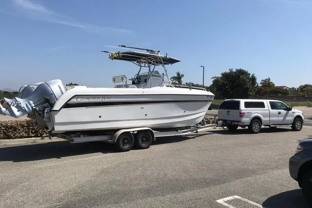 Slide: The Image of 2005 Glacier Bay 260 Canyon Runner boat on trailer, parked in a lot. - 4