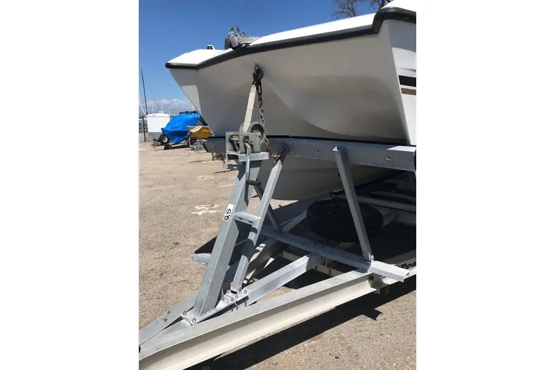 Slide: The Image of 2005 Glacier Bay 260 Canyon Runner boat on trailer, parked outdoors. - 5